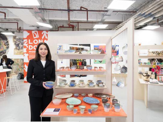 Woman with display of ceramics