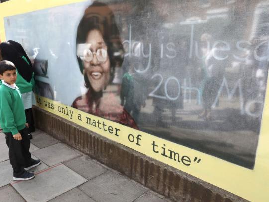 School child looks a mural of pioneering teacher Beryl Gilroy