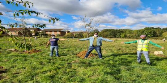 Three people standing in park green envrionment