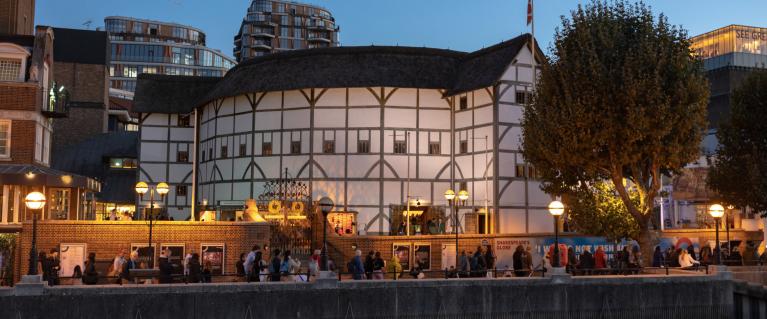The outside of the globe theatre in London at night