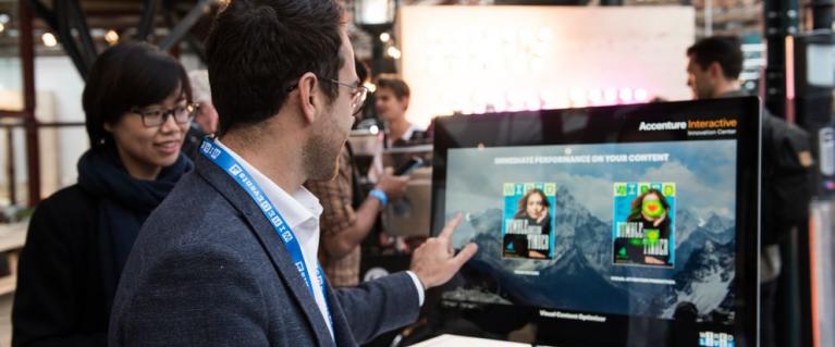 People looking at cleantech news on a screen