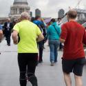 Group of people jogging over the Millennium Bridge