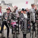 Pearly kings and queens waving flags at the Feast of St.George