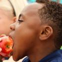 School boy eating apple
