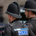 Two police officers walk side by side