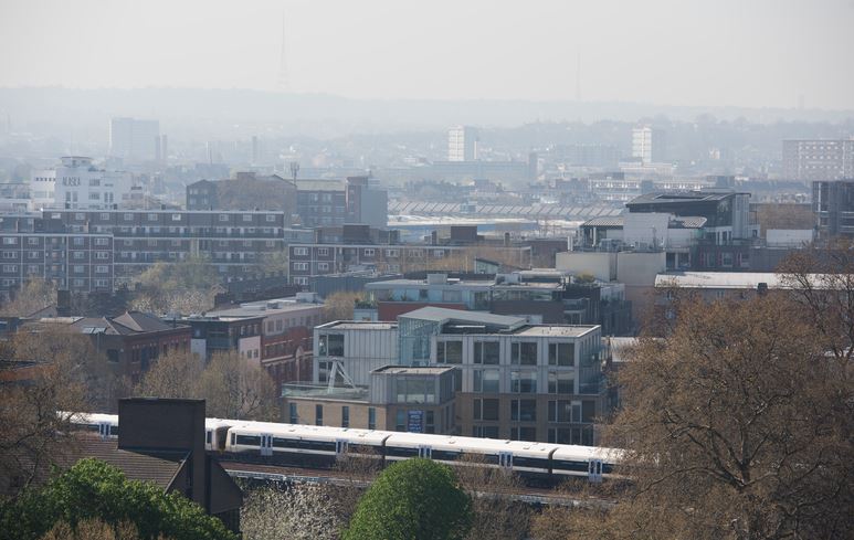 View of London incluidng a trainline and lots of buildings
